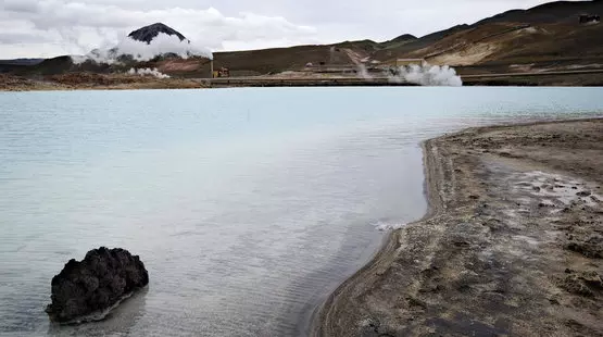 Mountainousland with a well and a huge bed of sea beside it 