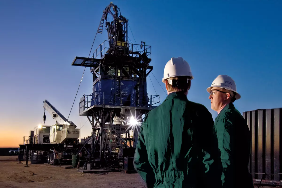 Photo of two engineers at a coiled tubing rig site.